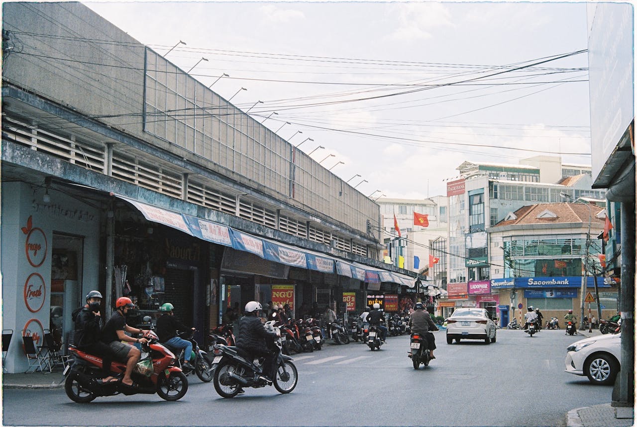 Busy street scene with motorbikes in Dalat, Vietnam, showcasing urban life.
